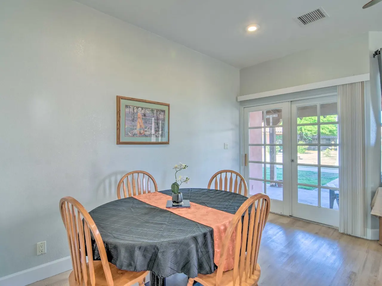 Casa 12 dining table by French doors to the patio