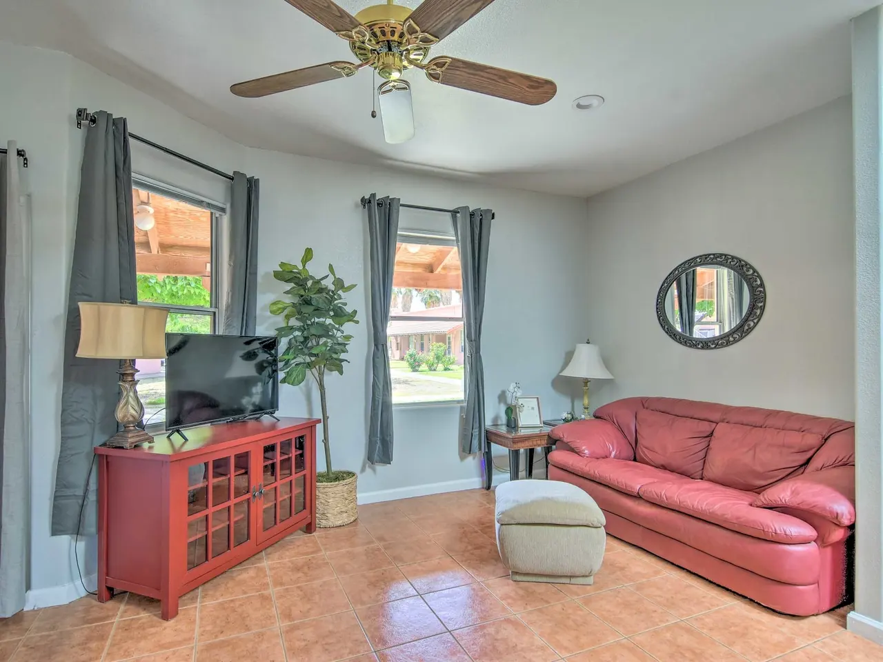 Casa 6 living room with a red leather sofa and dining table