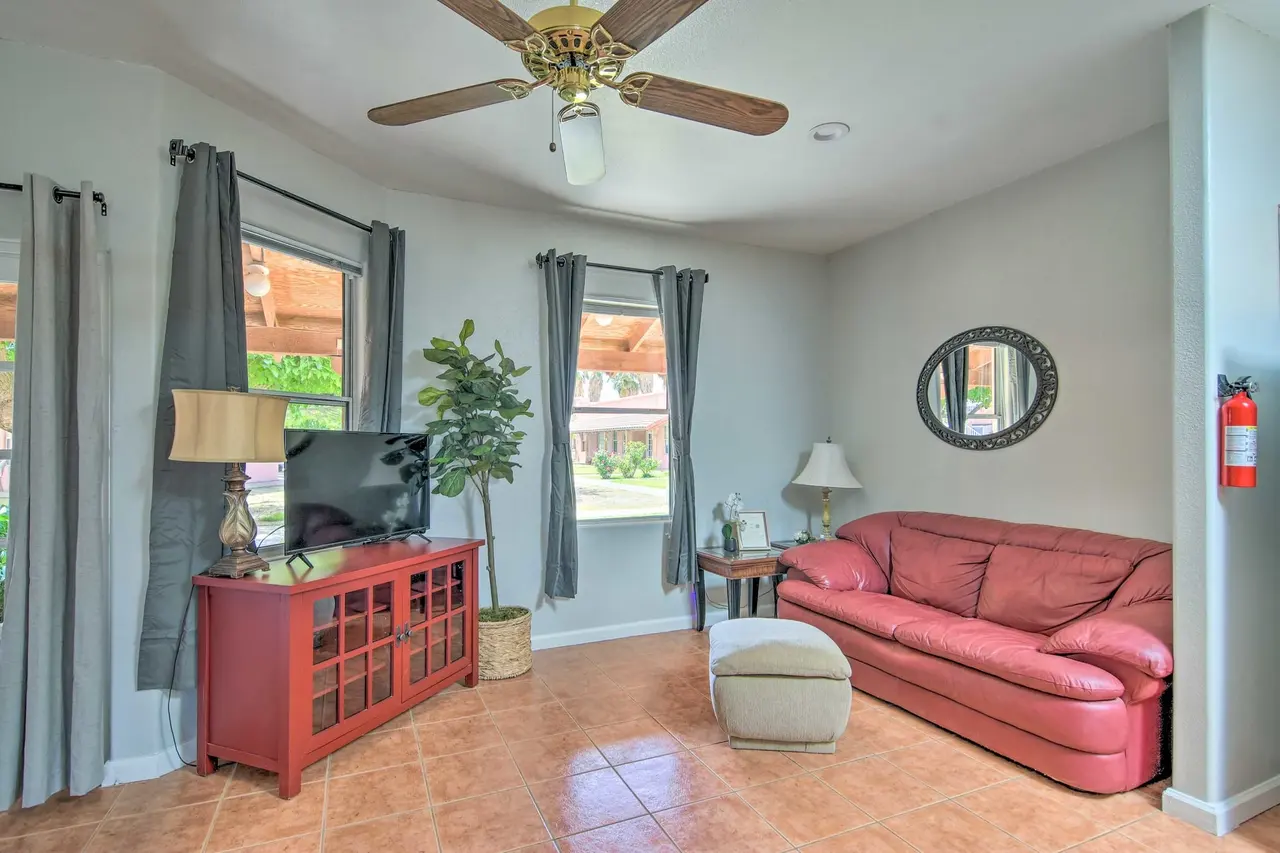 Casa 6 living room with a red leather sofa and dining table