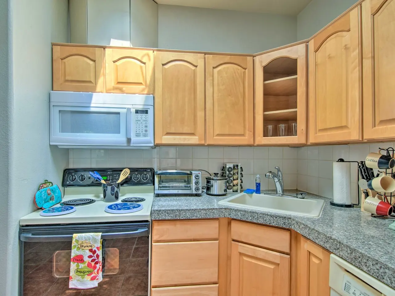 Casa 7 kitchen with stone counters and maple cabinets