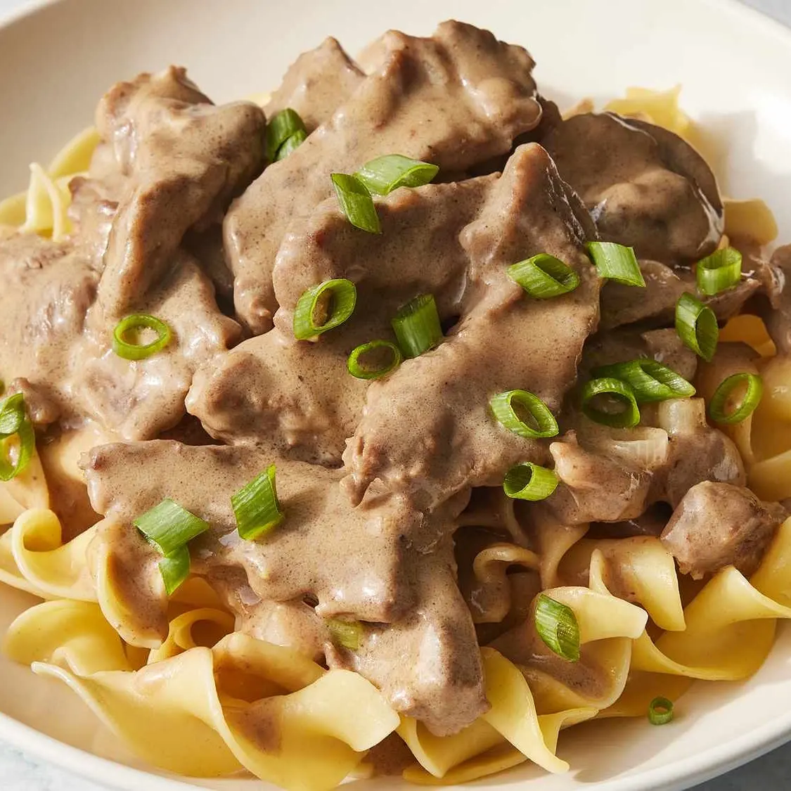 Beef stroganoff with mushrooms over egg noodles