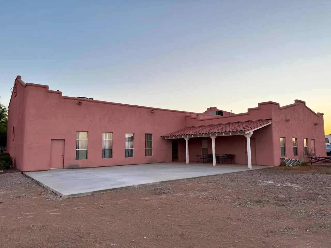 The meeting hall's covered patio and concrete terrace at first light