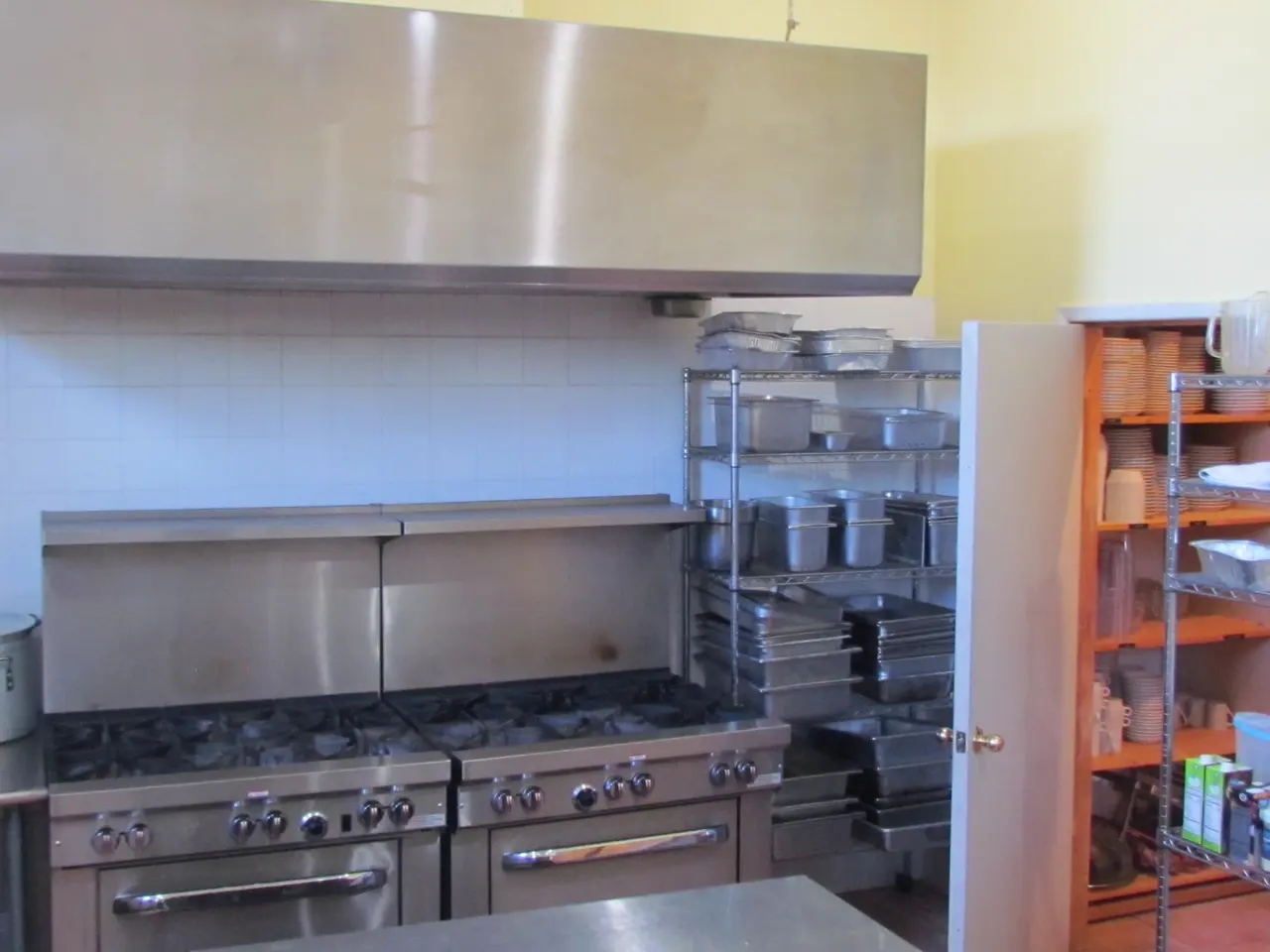 Twelve-burner range and stainless hood in the commercial kitchen