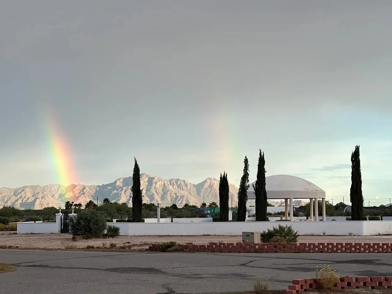 A double rainbow over the mountains after a desert storm