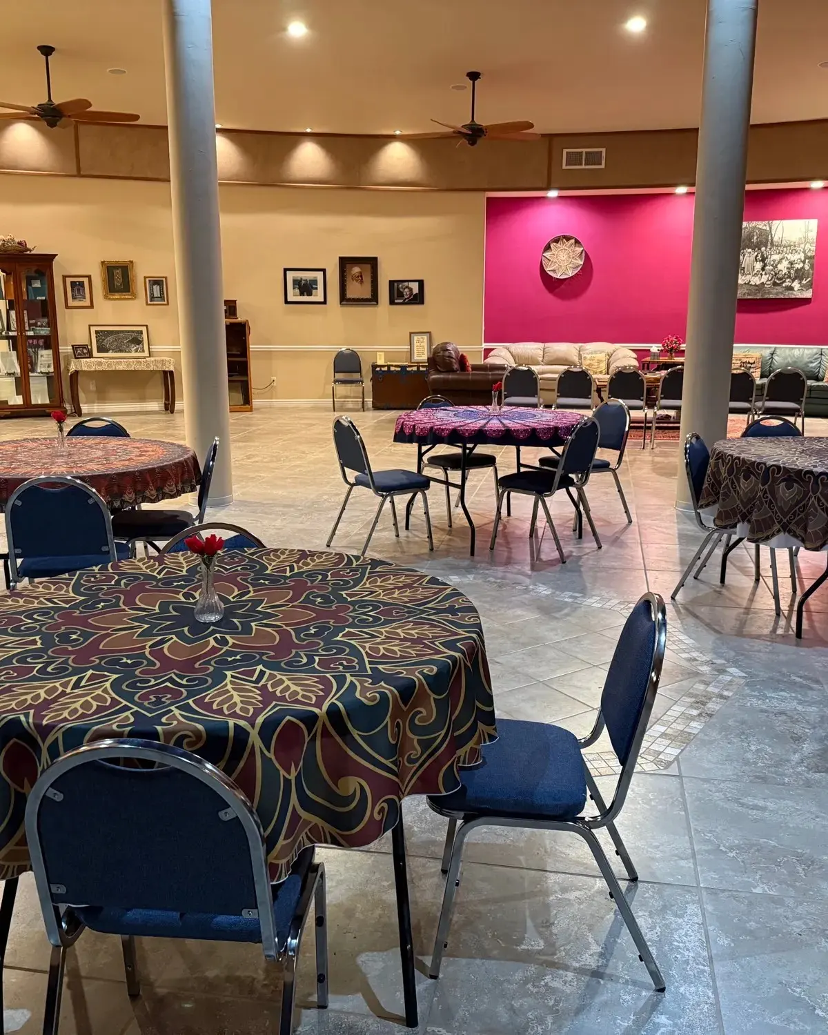 Round tables with patterned cloths beneath a clerestory dome
