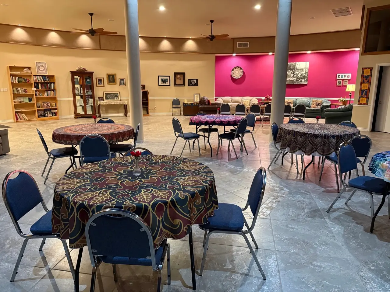 Round tables with patterned cloths beneath a clerestory dome